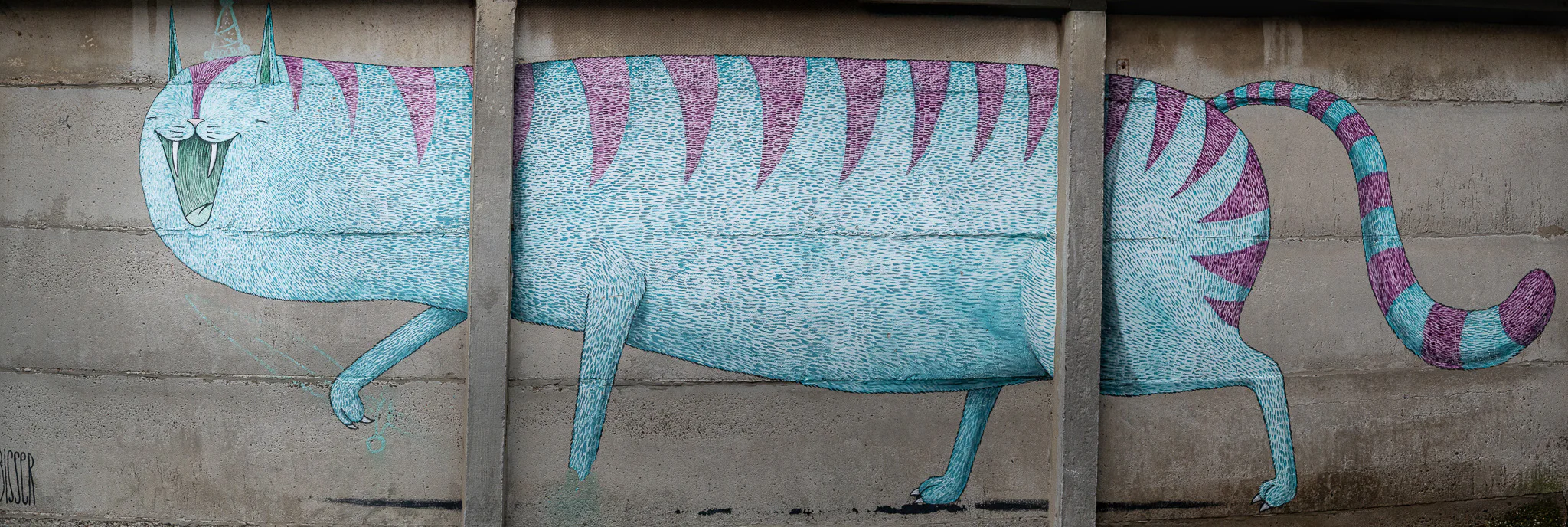 A panoramic blue cat mural extending across several concrete wall bays.