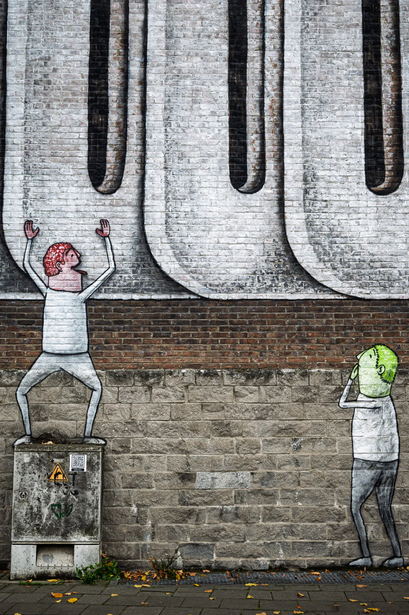 Two painted figures beneath the repeating grey forms of a large mural, one reaching upward while the other covers their face.